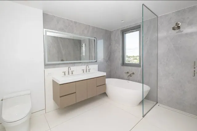 a bathroom with a sink toilet and shower