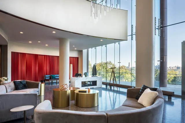 a living room with rug wall painting and a flat screen tv