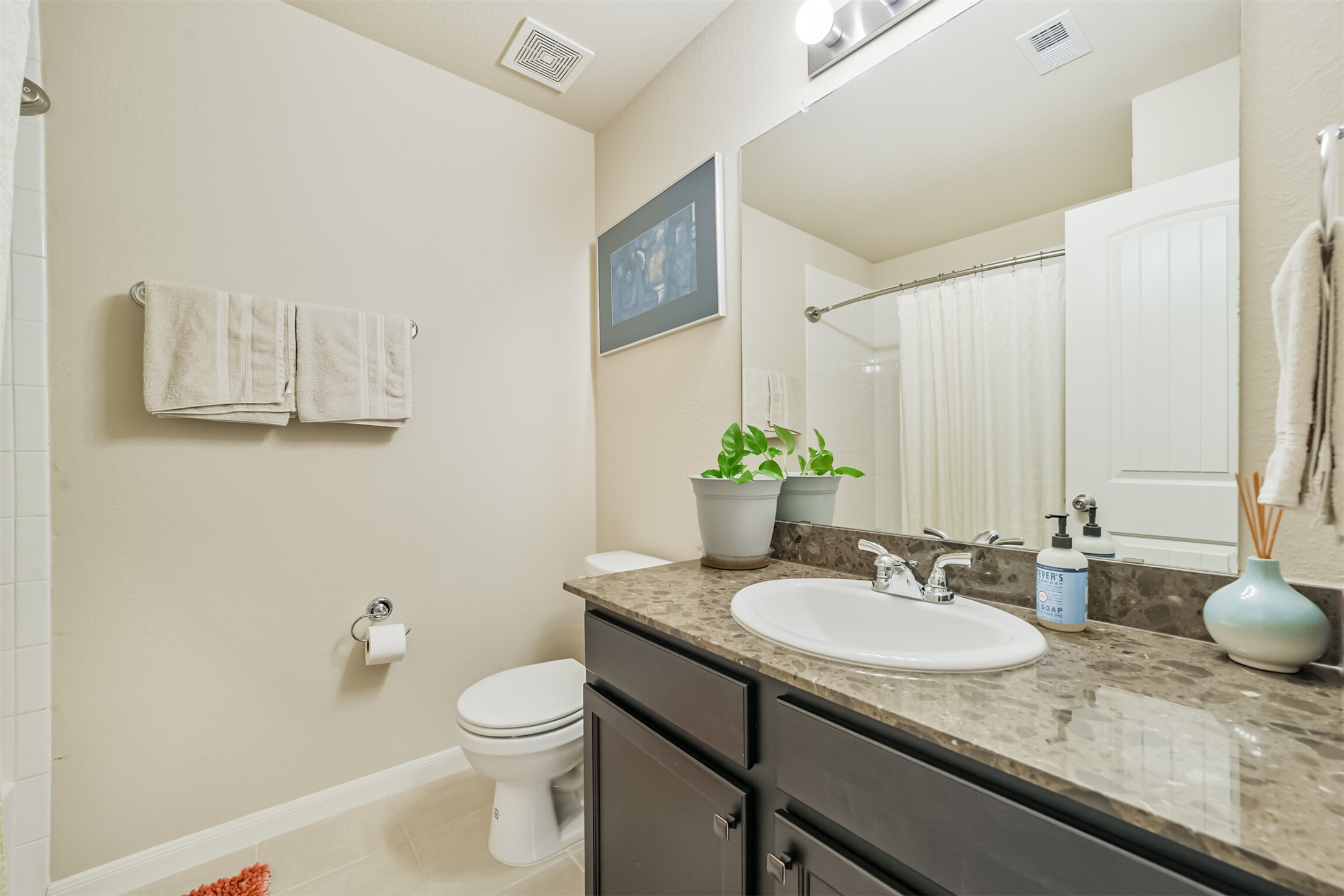 12009 La Salle River Road Conroe, TX 77304 - Photo 33 of 50 a bathroom with a granite countertop sink a toilet and mirror
