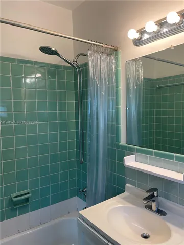 a bathroom with a sink mirror toilet and shower