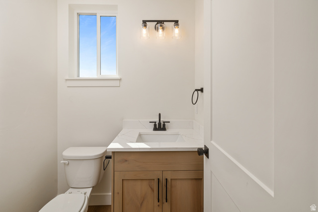 612 North 400 West Logan, UT 84321 - Photo 18 of 27 Bathroom featuring a natural wood-finish vanity with a white countertop and integrated sink