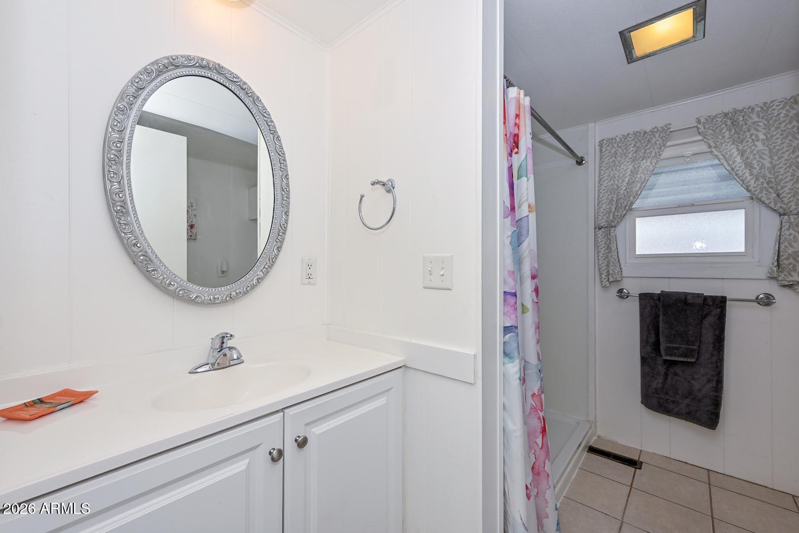 16225 North Cave Creek Road, Unit 79 Phoenix, AZ 85032 - Photo 13 of 32 a bathroom with a sink and a mirror