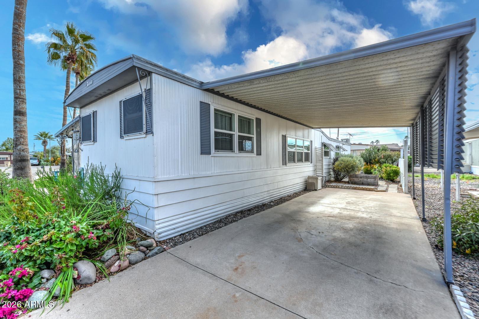 16225 North Cave Creek Road, Unit 79 Phoenix, AZ 85032 - Photo 20 of 32 a view of a house with a yard