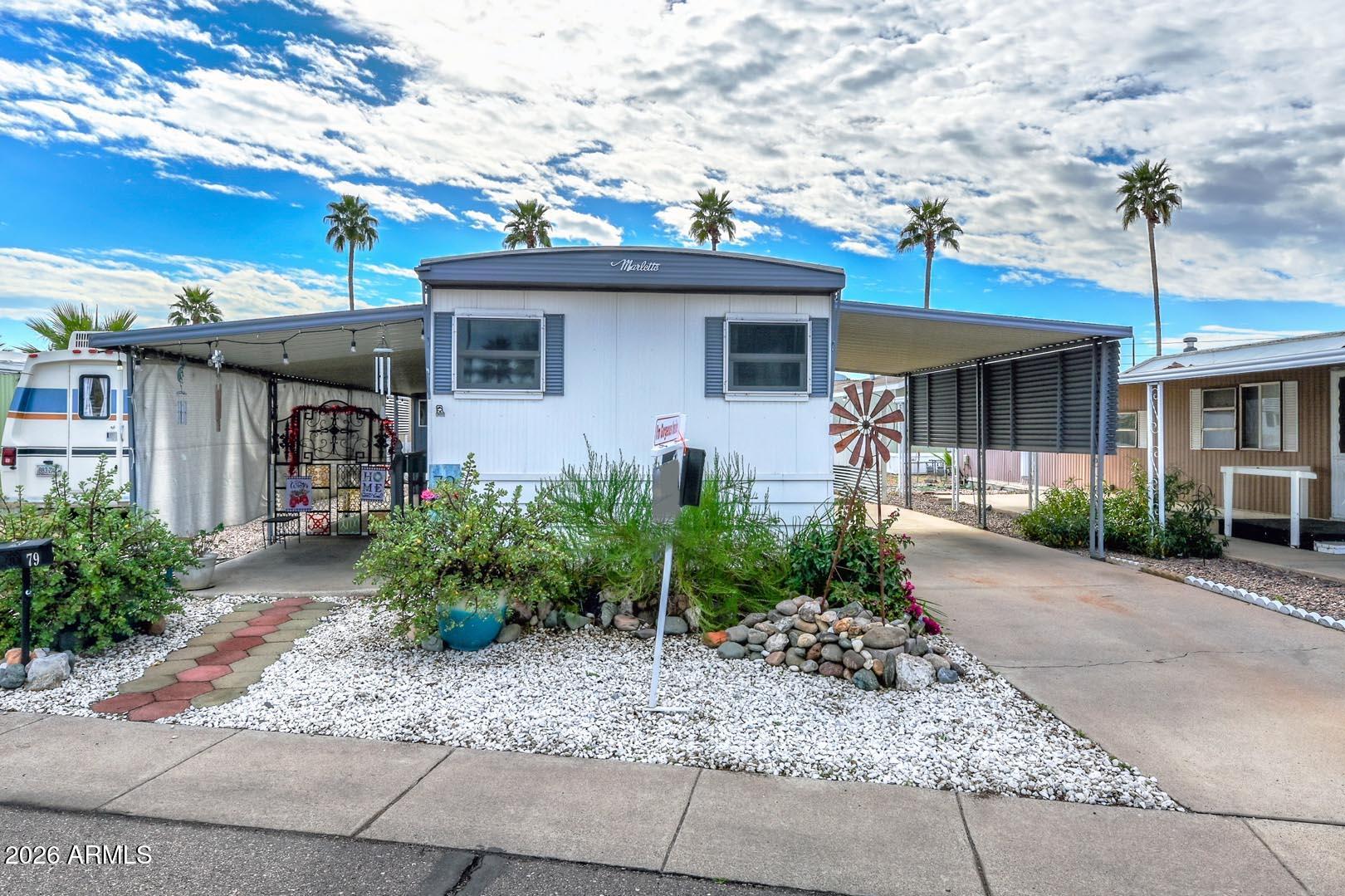 16225 North Cave Creek Road, Unit 79 Phoenix, AZ 85032 - Photo 2 of 32 a front view of a house with garden
