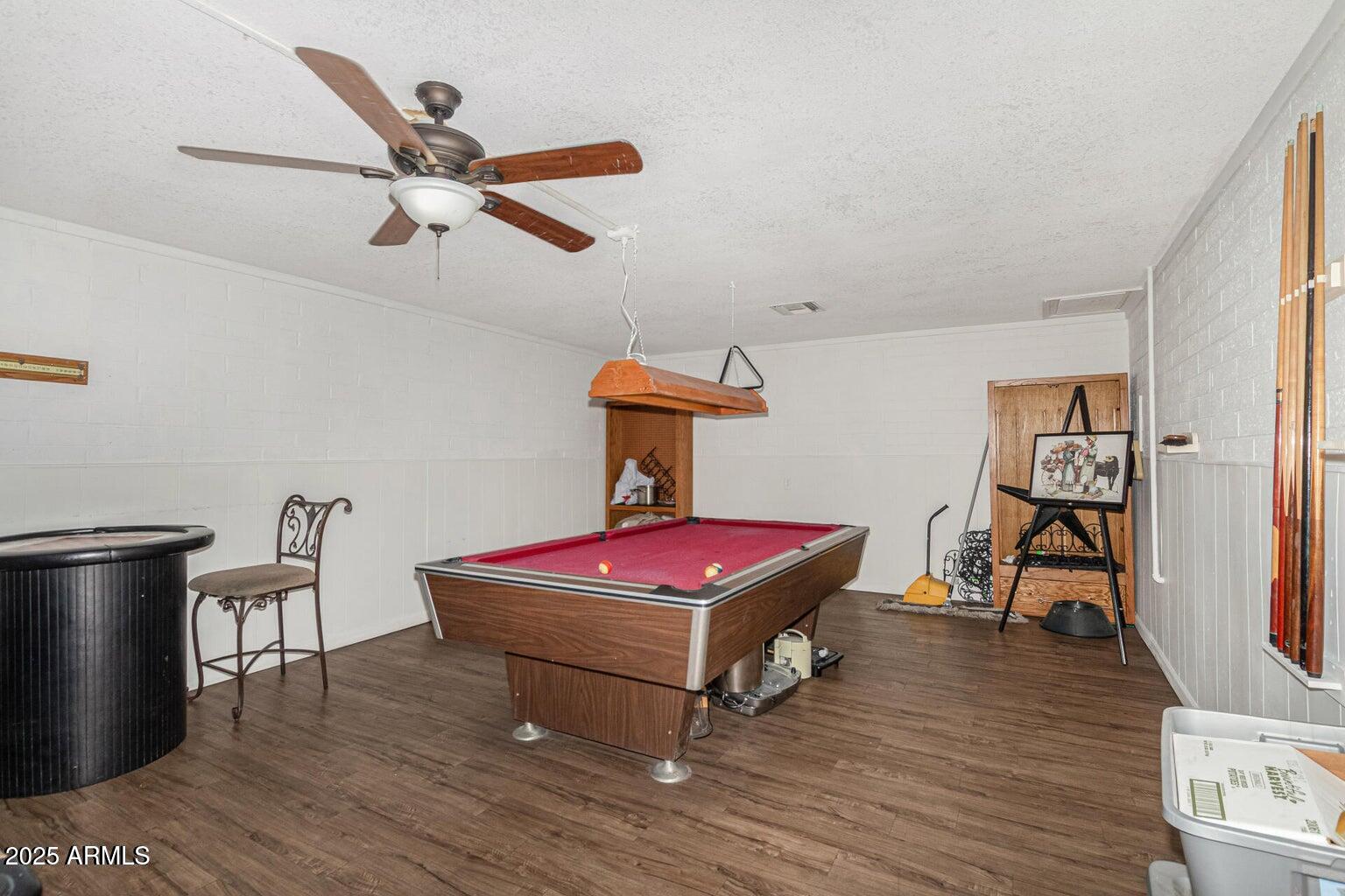 16225 North Cave Creek Road, Unit 79 Phoenix, AZ 85032 - Photo 25 of 32 a living room with hard wood floors and a ceiling fan