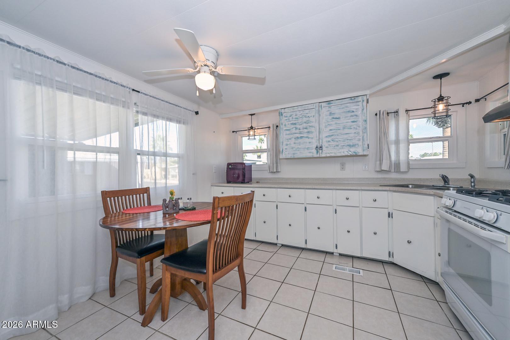 16225 North Cave Creek Road, Unit 79 Phoenix, AZ 85032 - Photo 3 of 32 a view of a dining room with furniture and window