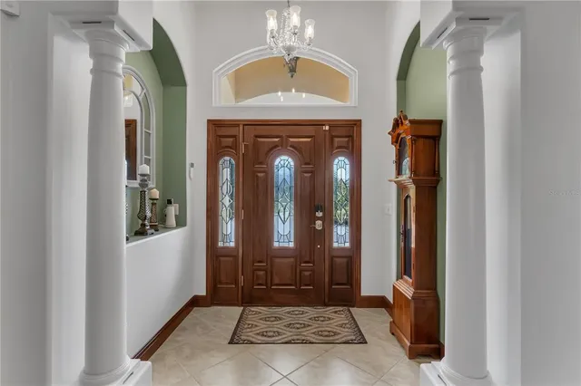 a bedroom with a bed and a flat tv screen on dresser