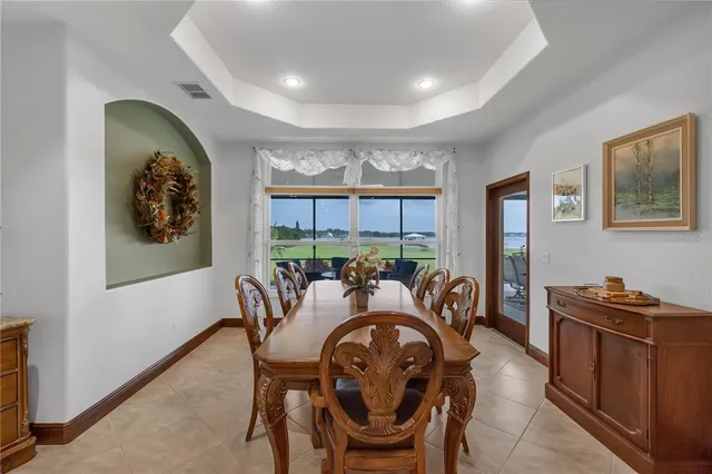 a spacious bedroom with a large bed and two mirrors