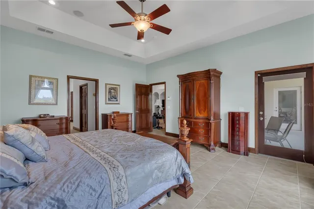 a bedroom with a bed closet and flat tv screen