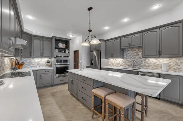 a kitchen with sink stove and cabinets