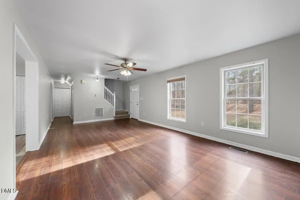 wooden floor in an empty room with a window