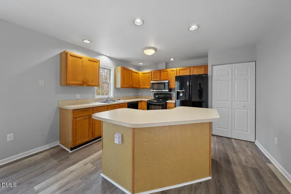 a view of kitchen with granite countertop cabinets and wooden floor