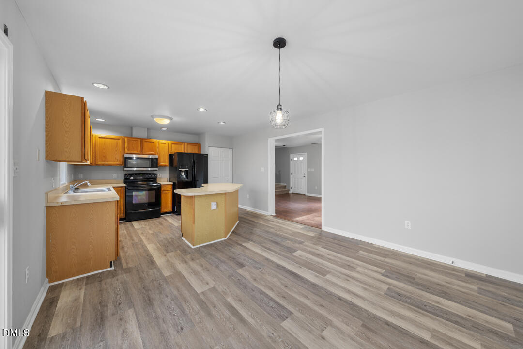 5523 Old Noble Road Cedar Grove, NC 27231 - Photo 5 of 16 a kitchen with a sink and microwave
