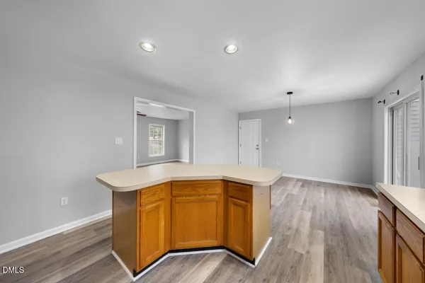 a view of kitchen with wooden floor and electronic appliances