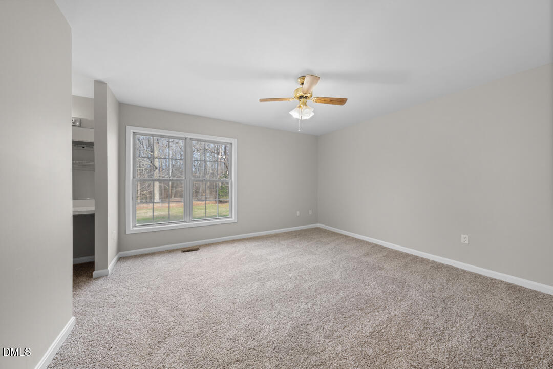 5523 Old Noble Road Cedar Grove, NC 27231 - Photo 10 of 16 an empty room with a window and a ceiling fan