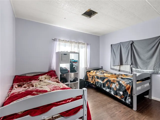 a bedroom with two beds and painted walls