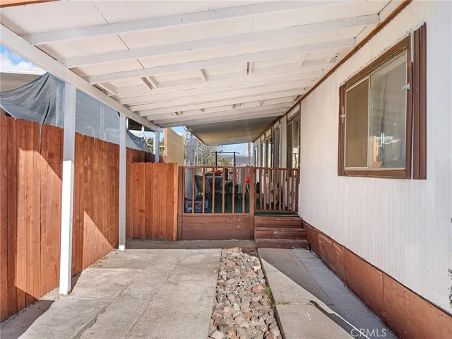 a view of a porch with wooden floor and stairs