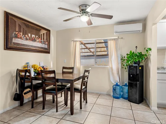a view of a dining room with furniture and a potted plant