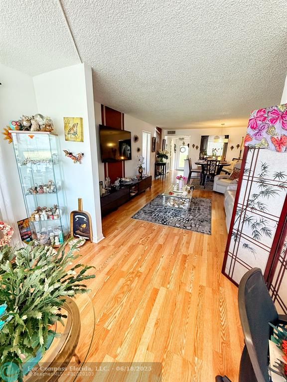 9881 Sunrise Lakes Boulevard, Unit 106 Sunrise, FL 33322 - Photo 15 of 22 a living room with furniture and a flat screen tv
