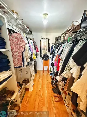 a view of walk in closet with clothes