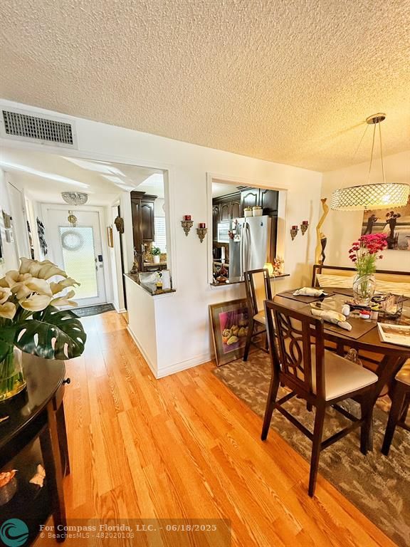 9881 Sunrise Lakes Boulevard, Unit 106 Sunrise, FL 33322 - Photo 3 of 22 a view of a dining room with furniture and a kitchen