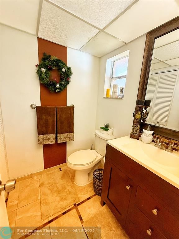 9881 Sunrise Lakes Boulevard, Unit 106 Sunrise, FL 33322 - Photo 5 of 22 a bathroom with a toilet sink and mirror