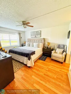 a bedroom with a bed and ceiling fan