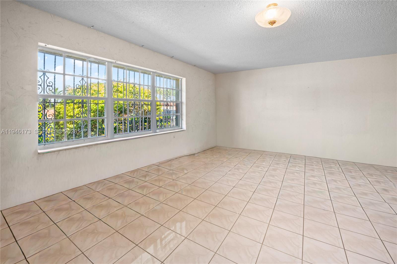 9730 Southwest 44th Street Miami, FL 33165 - Photo 12 of 53 a view of an empty room with a window