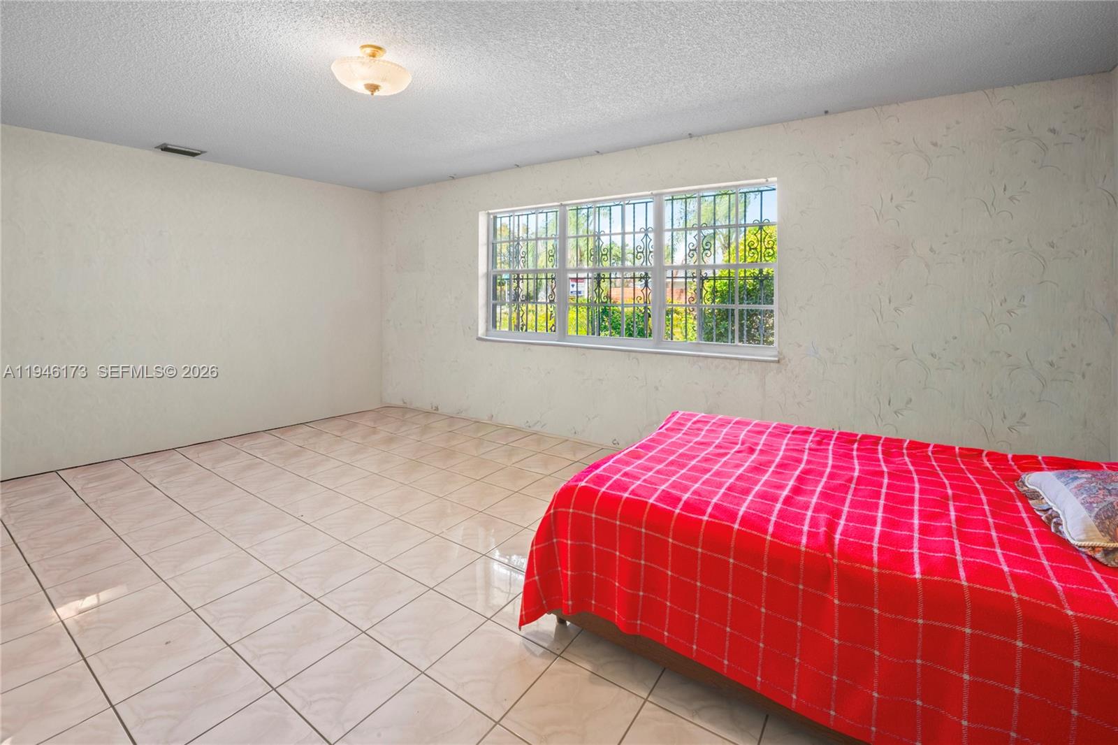 9730 Southwest 44th Street Miami, FL 33165 - Photo 14 of 53 a bedroom with a bed and a window