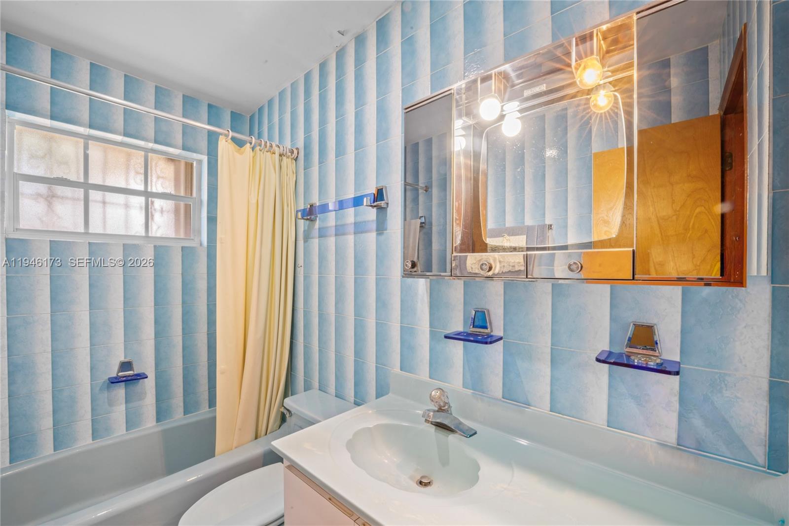 9730 Southwest 44th Street Miami, FL 33165 - Photo 25 of 53 a bathroom with a sink and a mirror