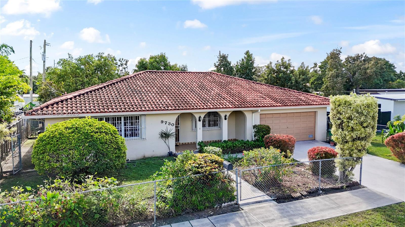 9730 Southwest 44th Street Miami, FL 33165 - Photo 50 of 53 a front view of a house with garden