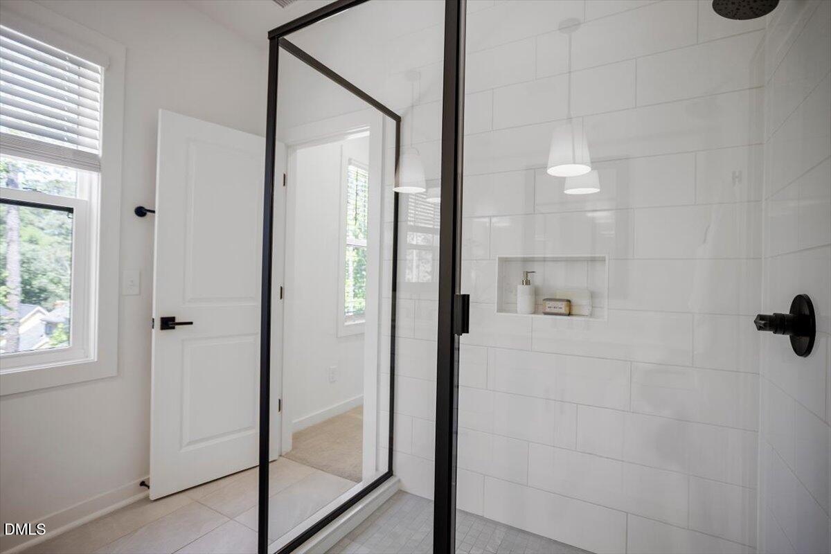 6419 Tanner Oak Lane Raleigh, NC 27613 - Photo 27 of 39 a bathroom with a glass shower door