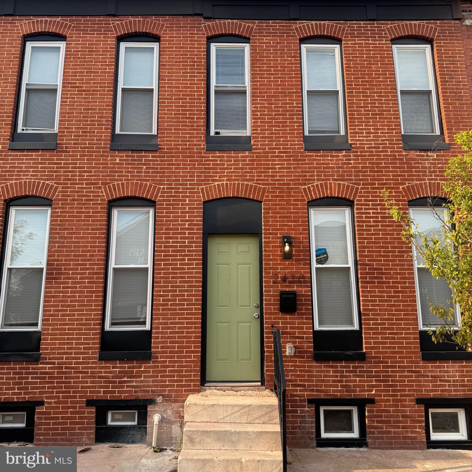 2430 East Biddle Street Baltimore, MD 21213 - Photo 2 of 26 a brick building that has lot of windows on it