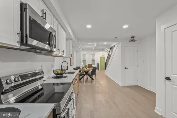 a kitchen with stainless steel appliances granite countertop a stove and a sink