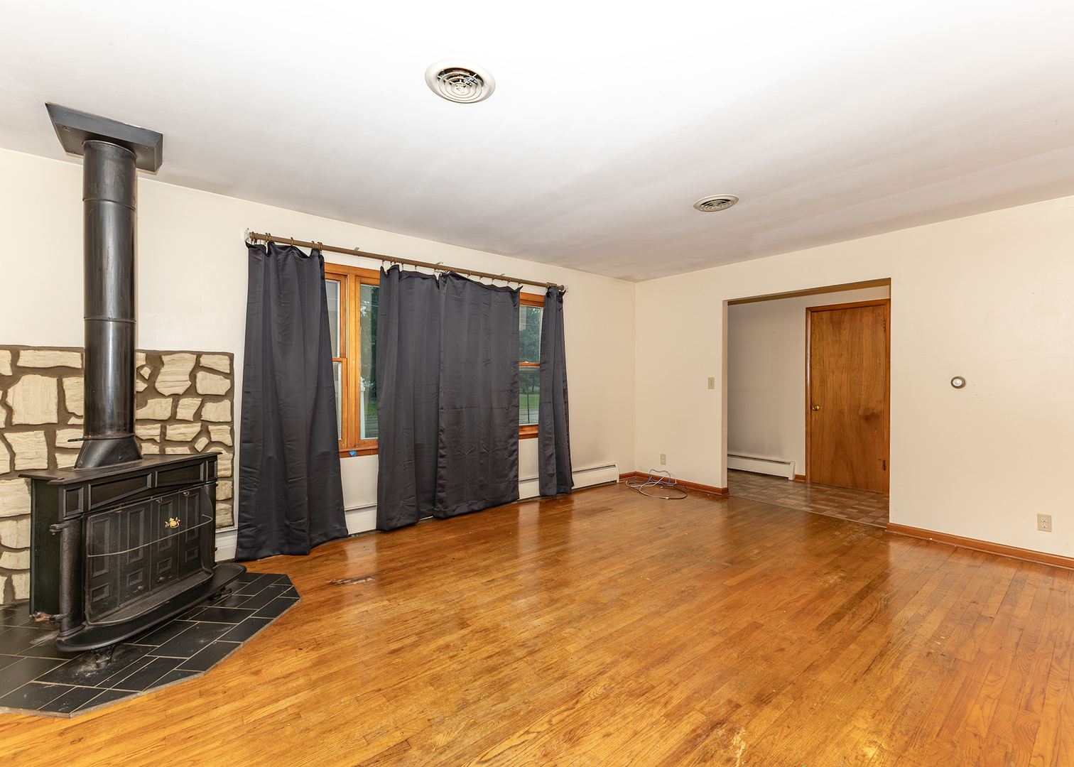 1608 3rd Street Camanche, IA 52730 - Photo 6 of 25 a view of an empty room with wooden floor