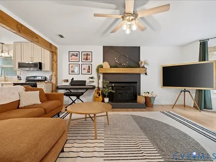 a living room with furniture a fireplace and a flat screen tv
