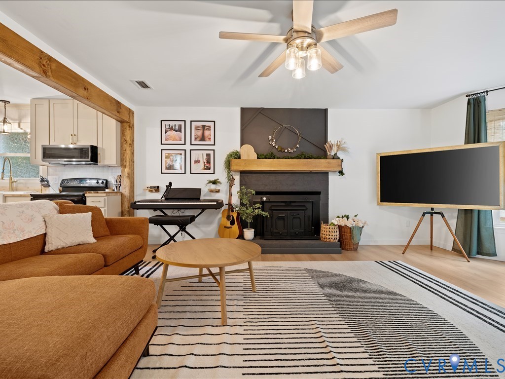 6806 Full Rack Circle Midlothian, VA 23112 - Photo 5 of 29 a living room with furniture a fireplace and a flat screen tv