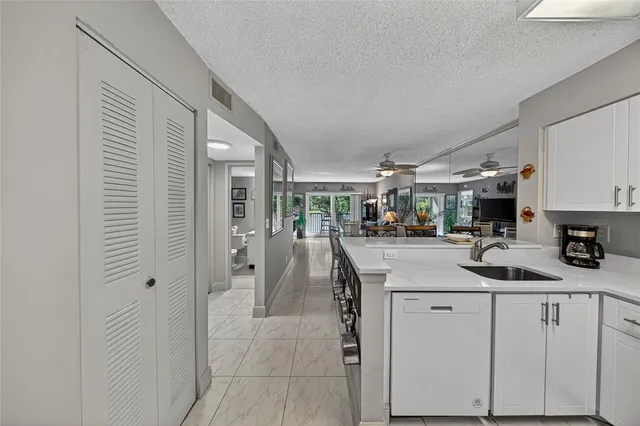 a kitchen with stainless steel appliances kitchen island granite countertop a sink and cabinets