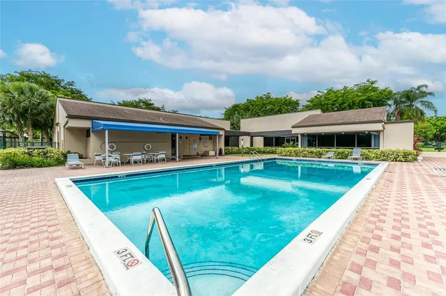 a view of a lake with a bench and bench in front of house
