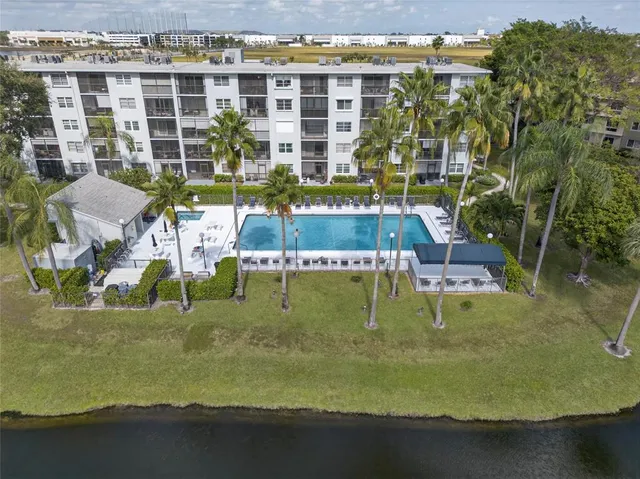 a kitchen with kitchen island a counter top space stainless steel appliances and cabinets