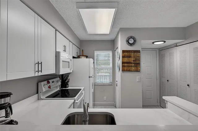 a living room with furniture a table and a bookshelf