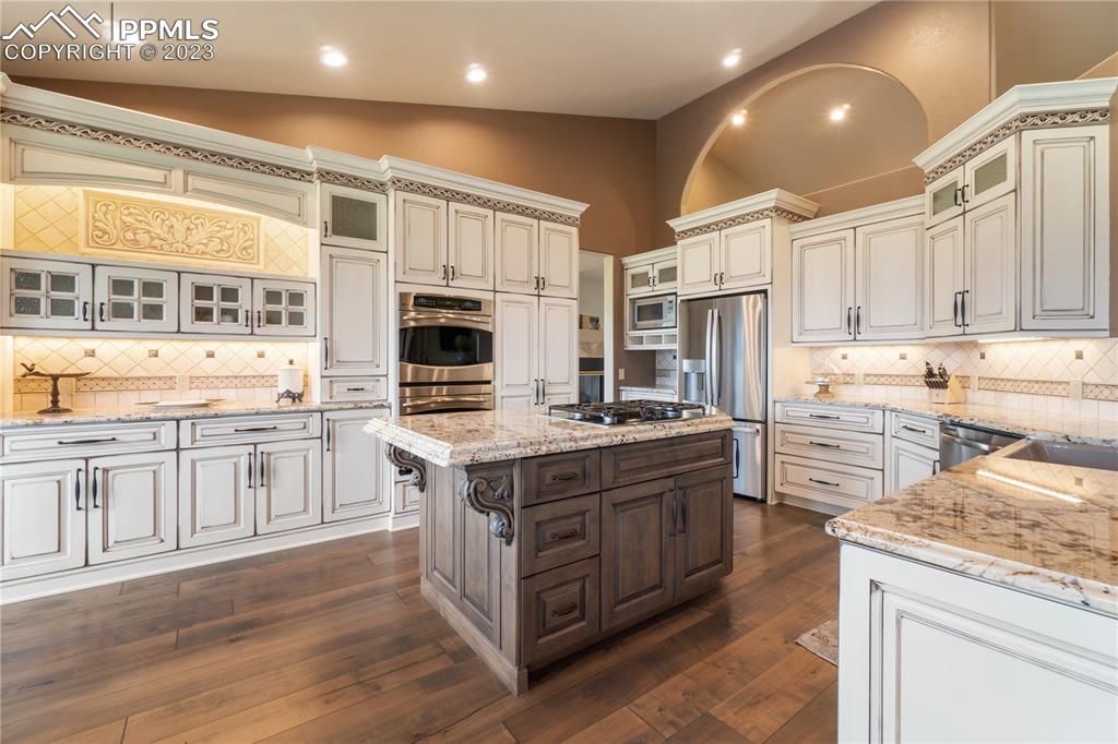 14525 Sterling Road Colorado Springs, CO 80921 - Photo 12 of 46 a kitchen with stainless steel appliances granite countertop a stove and a refrigerator