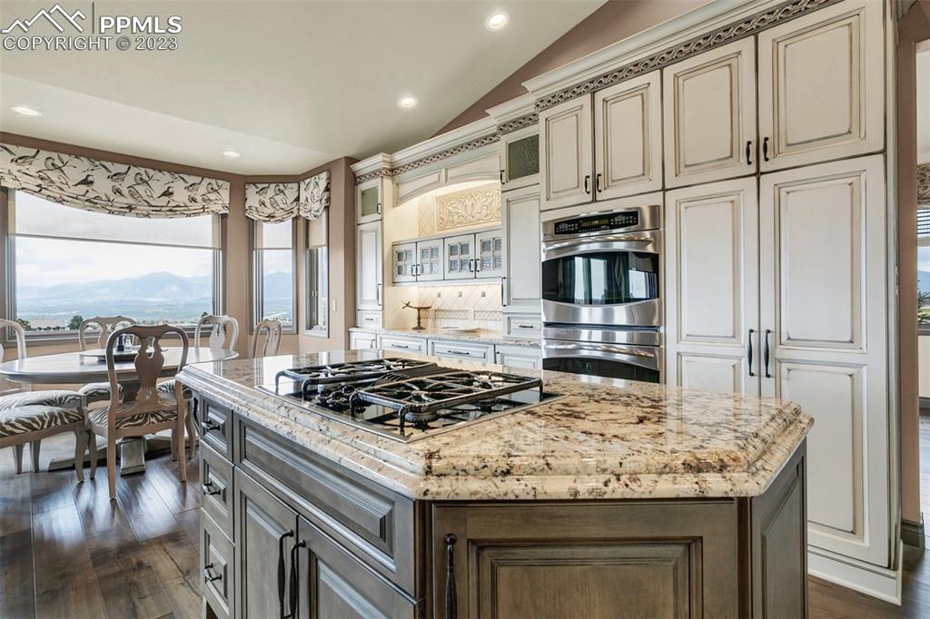 14525 Sterling Road Colorado Springs, CO 80921 - Photo 13 of 46 a kitchen with stainless steel appliances granite countertop a stove and a refrigerator