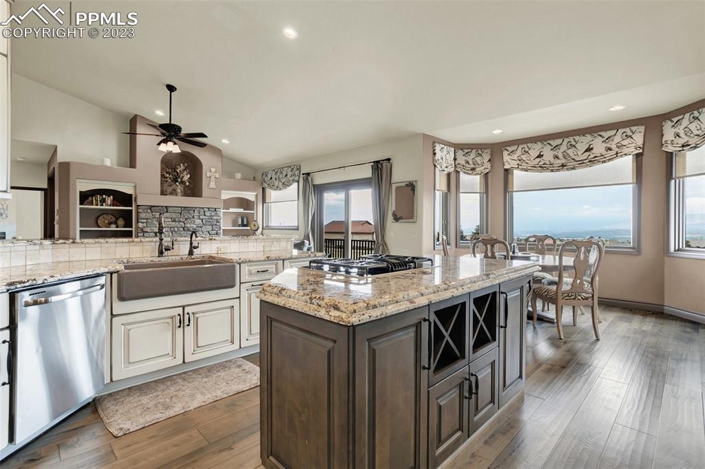 14525 Sterling Road Colorado Springs, CO 80921 - Photo 14 of 46 a kitchen with stainless steel appliances granite countertop a sink stove and wooden floor