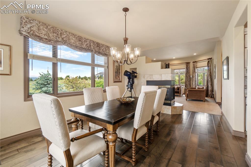 14525 Sterling Road Colorado Springs, CO 80921 - Photo 21 of 46 a view of a dining room with furniture window and wooden floor