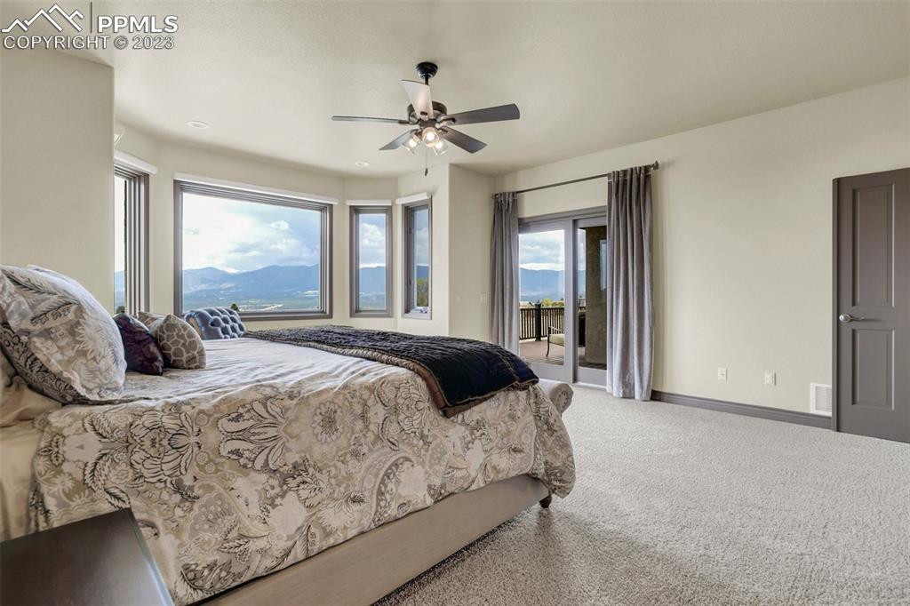14525 Sterling Road Colorado Springs, CO 80921 - Photo 23 of 46 a bedroom with a large bed and a chandelier