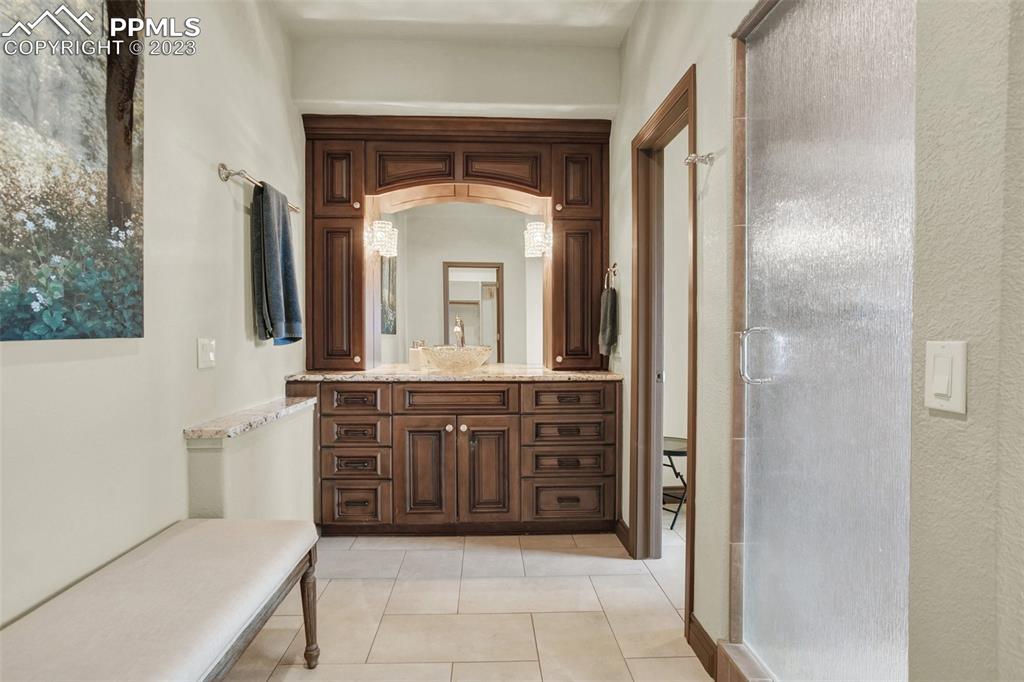 14525 Sterling Road Colorado Springs, CO 80921 - Photo 24 of 46 a bathroom with a vanity a sink a mirror a vanity and a window