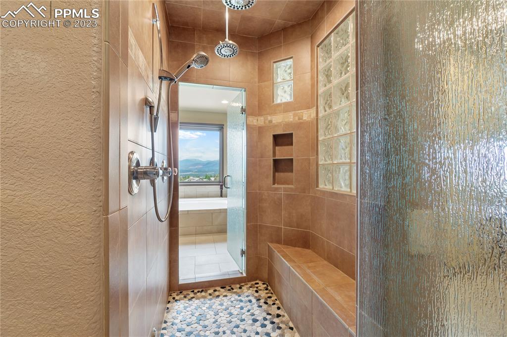 14525 Sterling Road Colorado Springs, CO 80921 - Photo 26 of 46 a bathroom with a glass shower door