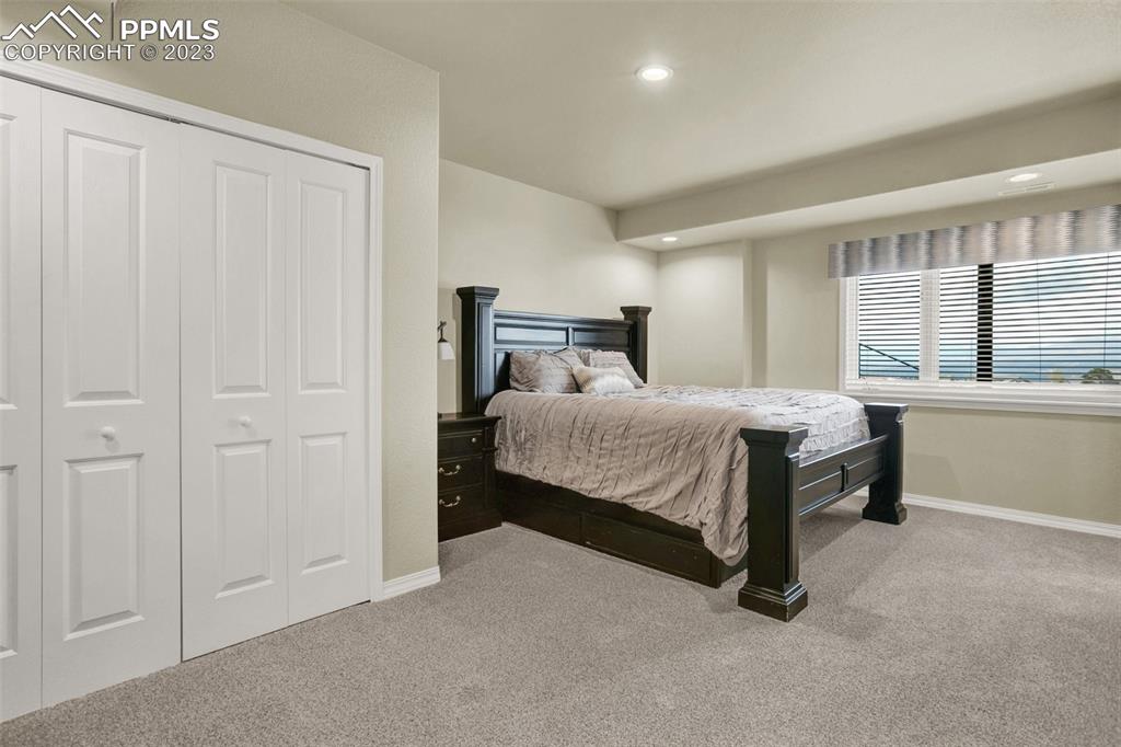 14525 Sterling Road Colorado Springs, CO 80921 - Photo 27 of 46 a bedroom with a bed and windows