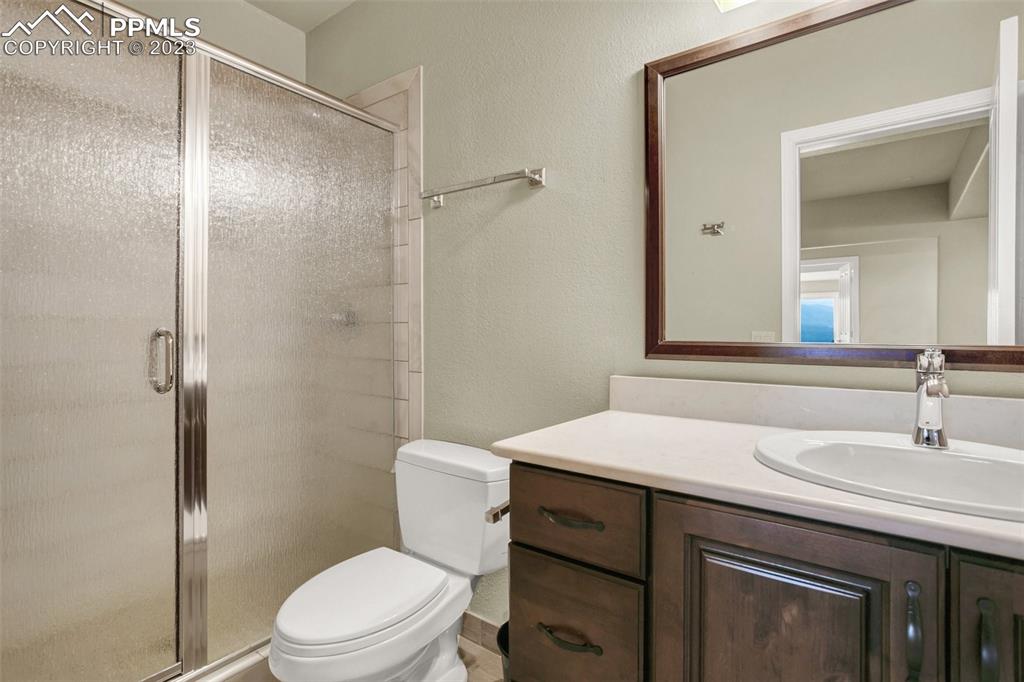 14525 Sterling Road Colorado Springs, CO 80921 - Photo 30 of 46 a bathroom with a sink toilet vanity and shower